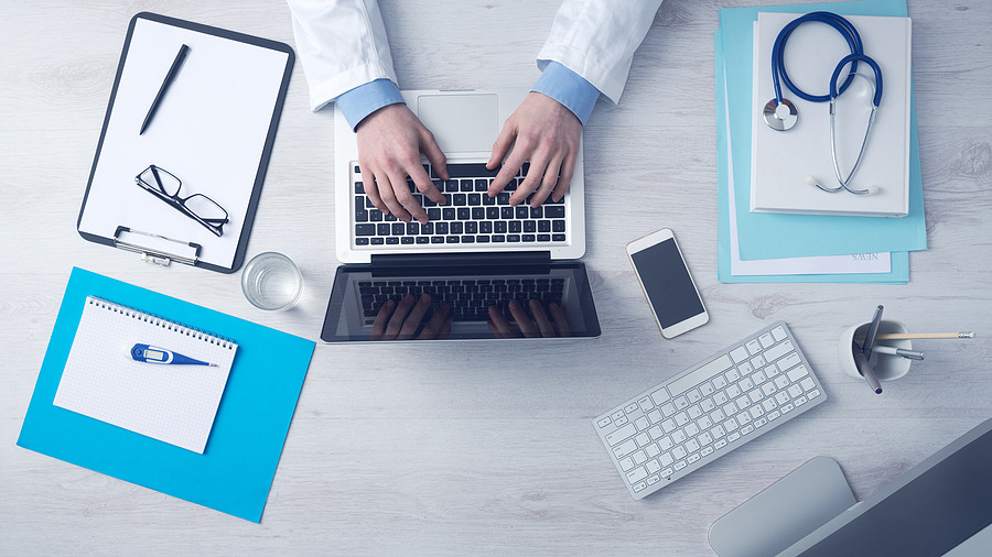 doctor reviewing medical website and taking notes